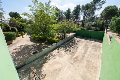 an overhead view of a garden with a green fence at Casa Farré next Barcelona Center in Pallejá