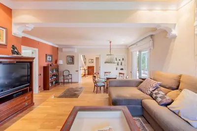 a living room with a couch and a tv at Casa Farré next Barcelona Center in Pallejá
