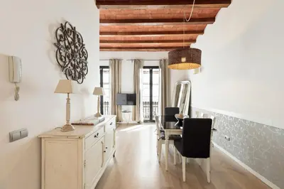 a dining room with white walls and a table and chairs at Enjoy Apartments Montserrat Boutique Apartment in Eixample in Barcelona