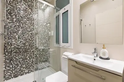 a bathroom with a shower and a sink and a toilet at Enjoy Apartments Montserrat Boutique Apartment in Eixample in Barcelona