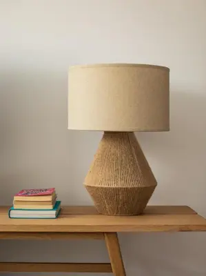 a lamp sitting on top of a table with books at Homing Barcelona 101 in Hospitalet de Llobregat
