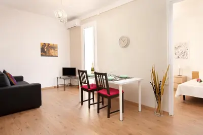 a living room with a white table and chairs at Centric Apartment El Molino Theater p1 in Barcelona