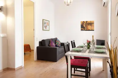a living room with a table and a couch at Centric Apartment El Molino Theater p1 in Barcelona