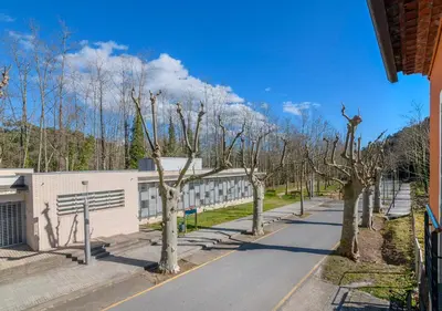 a street with trees in front of a building at Cal Metge de Gualba in gualba de Dalt
