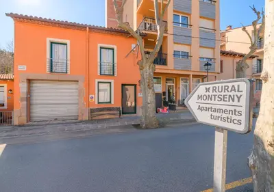 a sign on a street in front of a building at Cal Metge de Gualba in gualba de Dalt