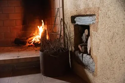 a brick oven with a fire in it at Masia Casa Nova de n'Illa in Montseny