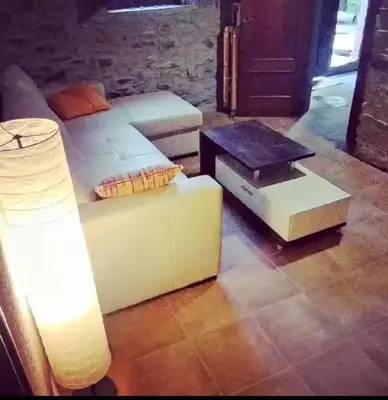 a living room with a couch and a table at Masia Casa Nova de n'Illa in Montseny