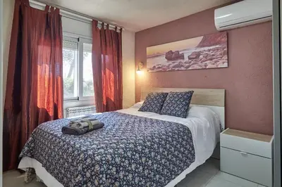 a bedroom with a bed with a backpack on it at Villa Soledad en Olivella, Sitges, Barcelona in Olivella