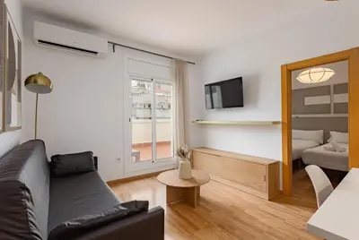 a living room with a couch and a table at Ola Living Sagrada Familia in Barcelona