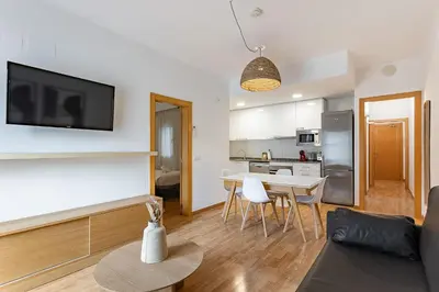 a living room with a couch and a table with chairs at Ola Living Sagrada Familia in Barcelona