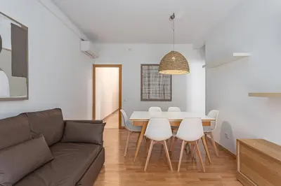 a living room with a couch and a tv at Ola Living Sagrada Familia in Barcelona