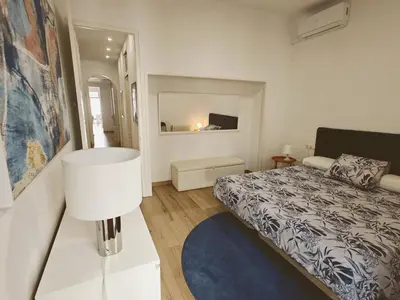 a small bedroom with a bed and a mirror at Apartamento nuevo en Terrassa Centro in Terrassa