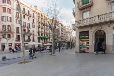 a city street with buildings and people walking on the street at Housalia Sant Pau Views- Suite with View on Hospital Sant Pau in Barcelona