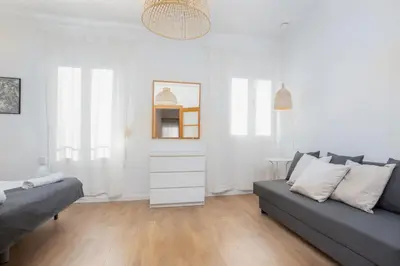 a living room with a couch and a table at Housalia Lepant 3 bedroom apartment 300 meters de Sagrada Familia in Barcelona