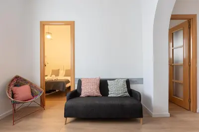 a living room with a couch and a chair at Housalia Lepant 3 bedroom apartment 300 meters de Sagrada Familia in Barcelona