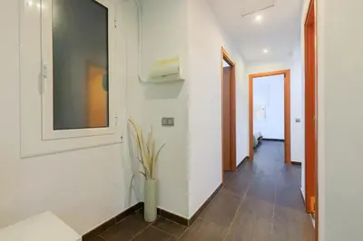 a hallway with white walls and a vase with a plant at Housalia Corsega - Apartment 3 bedrooms next to Sagrada Familia in Barcelona