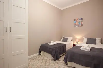 a small room with two beds and a closet at Enjoy Apartments Sofia in Barcelona