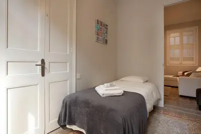 a bedroom with a bed with towels on it at Enjoy Apartments Sofia in Barcelona