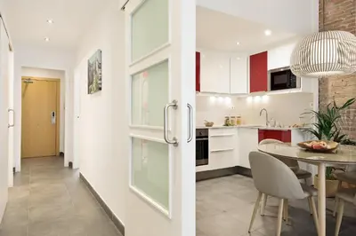 a kitchen and dining room with a table and chairs at Ola Living MACBA in Barcelona