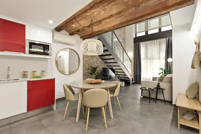 a kitchen and dining room with a table and chairs at Ola Living MACBA in Barcelona