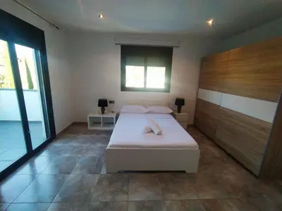 a bedroom with a white bed and a window at Villa Franz House Casa Principal in Canyelles