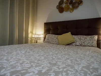 a bedroom with a large bed with a large headboard at Apartamento al lado Del Mar in Sant Adria de Besos