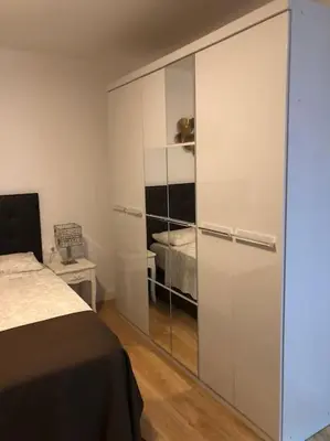 a bedroom with a bed and a glass closet at Apartamento al lado Del Mar in Sant Adria de Besos