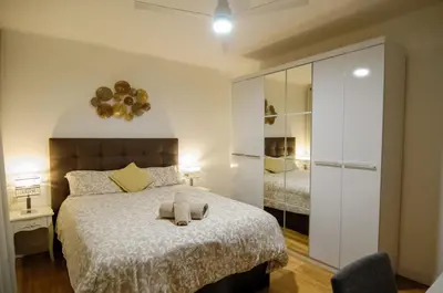 a bedroom with a large bed and a mirror at Apartamento al lado Del Mar in Sant Adria de Besos