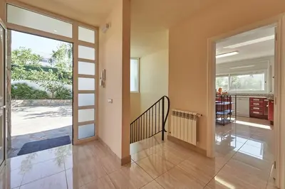 a hallway with a sliding glass door and a staircase at Villa lluna en Olivella, Sitges, Barcelona in Olivella