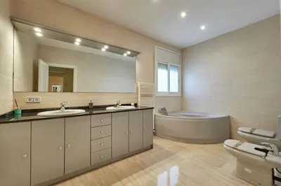 a large bathroom with two sinks and a tub at Villa lluna en Olivella, Sitges, Barcelona in Olivella
