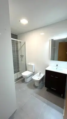 a bathroom with a sink and a toilet and a shower at Dúplex con terraza by Prestigi in Terrassa