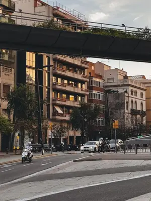 a busy city street with cars and a motorcycle at The Orbit Apartments in Barcelona