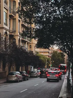 a busy city street with cars parked on the road at The Orbit Apartments in Barcelona