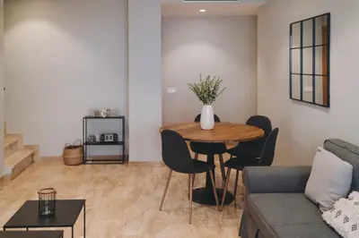 a living room with a table and a couch at The Orbit Apartments in Barcelona