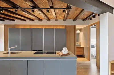 a kitchen with white cabinets and a sink at Enjoy Apartments La Riera Penthouse in Barcelona
