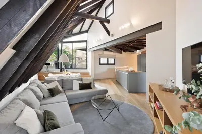 an open living room with a couch and a table at Enjoy Apartments La Riera Penthouse in Barcelona