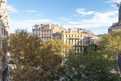a group of buildings in a city with trees at Central & Fully Equipped Apartment in Eixample Next to Metro, Sleeps 5 in Barcelona