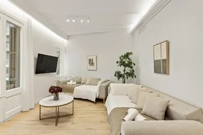 a white living room with a couch and a table at Modern & stylish apartment in Barcelona in Barcelona