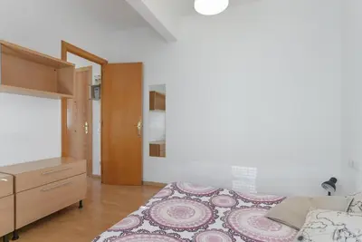 a bedroom with a bed and a dresser in it at ApartEasy - Lightly, central and quiet apartment in Barcelona