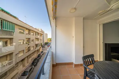 a balcony with a table and chairs and a street at HomeHolidaysRentals Deva - Costa Barcelona in Pineda de Mar