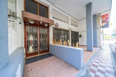 a building with a row of chairs outside of it at HomeHolidaysRentals Deva - Costa Barcelona in Pineda de Mar