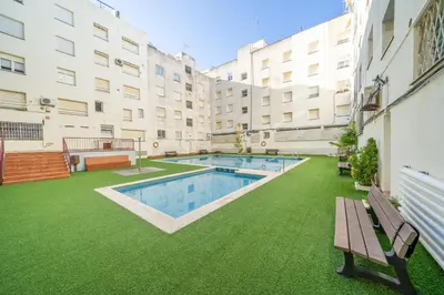 a courtyard with a swimming pool in a building at HomeHolidaysRentals Deva - Costa Barcelona in Pineda de Mar