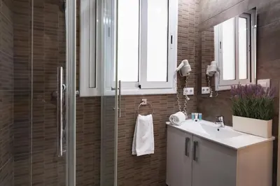 a bathroom with a sink and a shower at Elegance and Comfort in Barcelona, 4Bedroom Apartment in the Most Exclusive Area in Barcelona