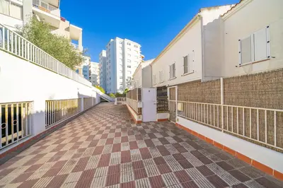 an empty walkway in a city with buildings at HomeHolidaysRentals Ancora - Costa Barcelona in San Pol de Mar