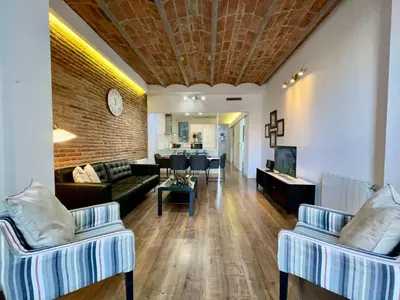 a living room with a couch and a table at BarcelonaForRent Tucson Suites in Barcelona