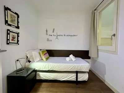 a small room with a bed and a desk at BarcelonaForRent Tucson Suites in Barcelona