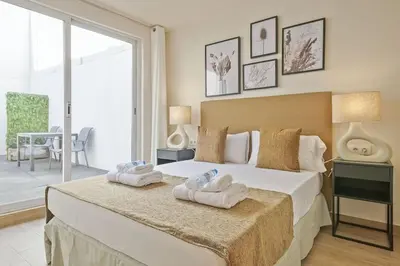 a bedroom with a large bed with towels on it at Alcam Galileu in Barcelona