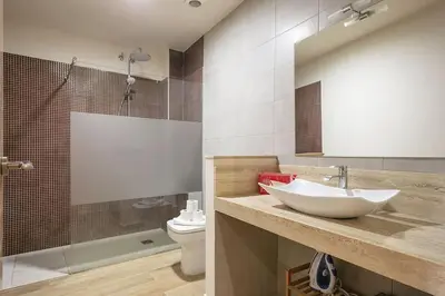 a bathroom with a sink and a toilet and a shower at Alcam Galileu in Barcelona