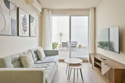 a living room with a couch and a table at Alcam Galileu in Barcelona