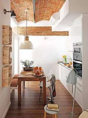 a kitchen with a wooden table in a room at Charming Parallel in Barcelona